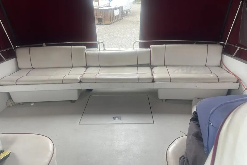 Slide: The Image of 1987 Chris-Craft 332 Amerosport boat interior with white seating and maroon canopy. - 15