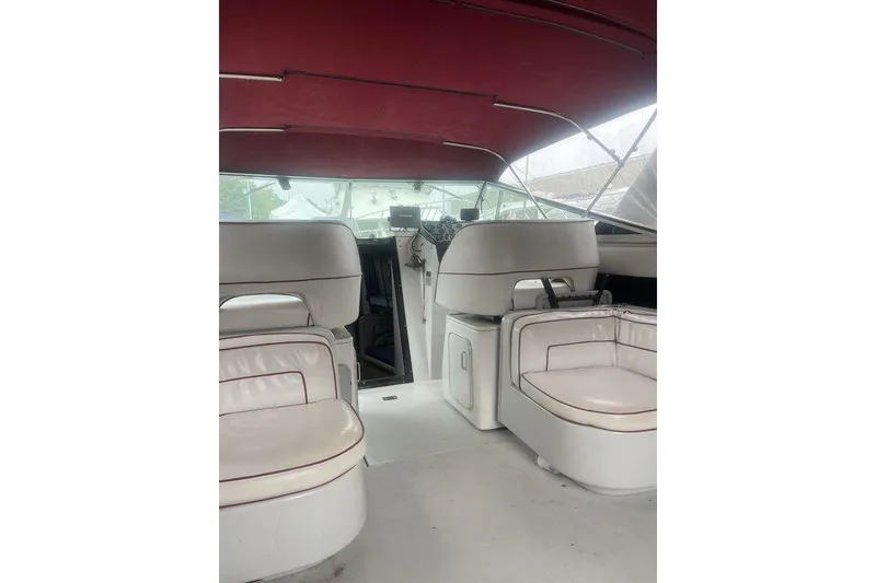 Slide: The Image of 1987 Chris-Craft 332 Amerosport boat interior with white seating and red canopy. - 16