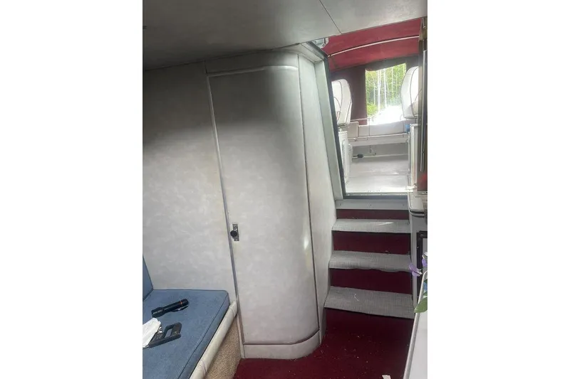 Slide: The Image of Interior view of 1987 Chris-Craft 332 Amerosport boat with stairs and seating area. - 18