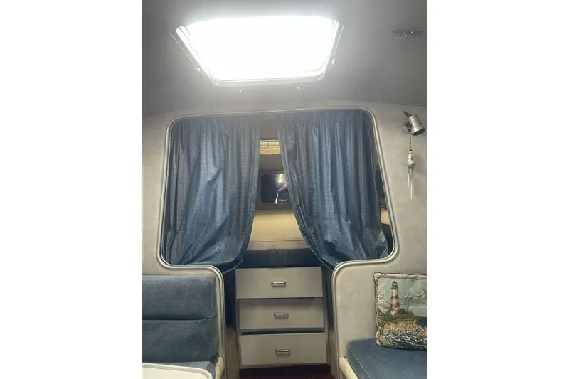 Slide: The Image of Interior of 1987 Chris-Craft 332 Amerosport with blue curtains and drawers. - 21