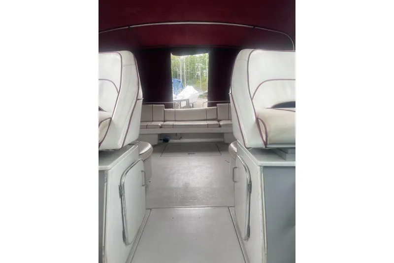 Slide: The Image of Interior of 1987 Chris-Craft 332 Amerosport boat with white seating and maroon canopy. - 22