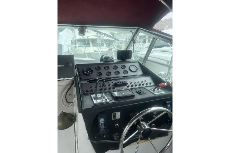 Slide: The Image of 1987 Chris-Craft 332 Amerosport helm with gauges, controls, and steering wheel. - 4