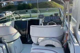 Slide: The Image of 1987 Chris-Craft 332 Amerosport boat interior with steering wheel and seating area. - 5