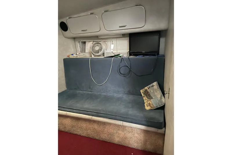 Slide: The Image of Interior of 1987 Chris-Craft 332 Amerosport with blue seating, fan, and TV. - 8