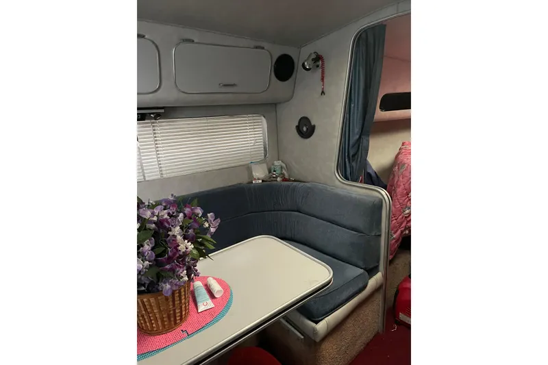 Slide: The Image of Interior of 1987 Chris-Craft 332 Amerosport with cozy seating and floral decor. - 9