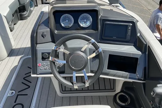 Slide: The Image of 2025 Avalon LSZ Quad Lounge Shift boat dashboard with steering wheel and control panel. - 10