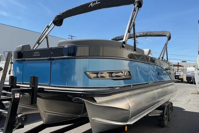 Slide: The Image of 2025 Avalon LSZ Quad Lounge Shift pontoon boat with sleek blue design and modern features. - 3