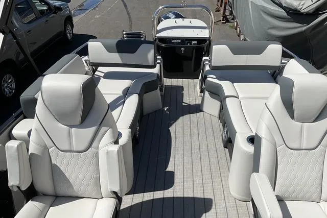 Slide: The Image of 2025 Avalon LSZ Quad Lounge Shift pontoon boat with luxurious seating and modern design. - 7