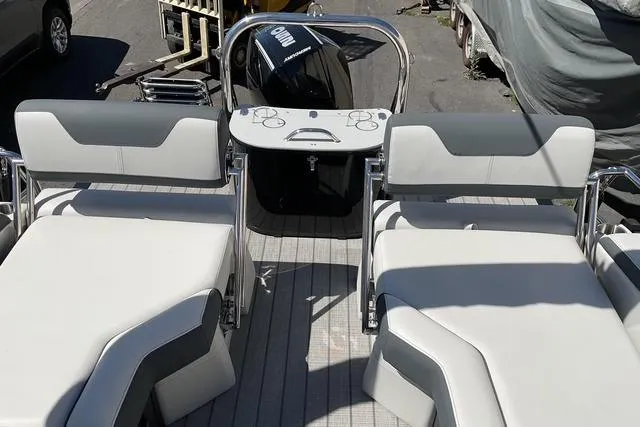 Slide: The Image of 2025 Avalon LSZ Quad Lounge Shift boat interior with modern seating and control panel. - 8