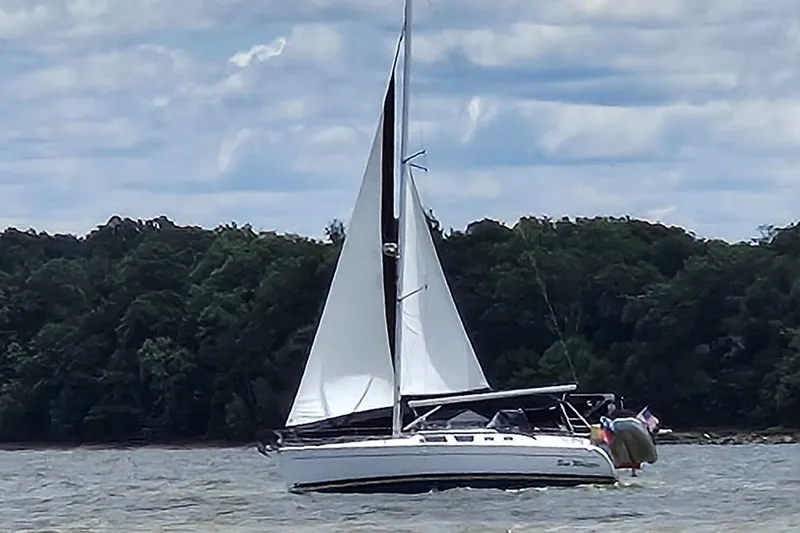 The Image of Sailing yacht Hunter 41 Deck Salon 2006 on a lake with forested shoreline. - 0