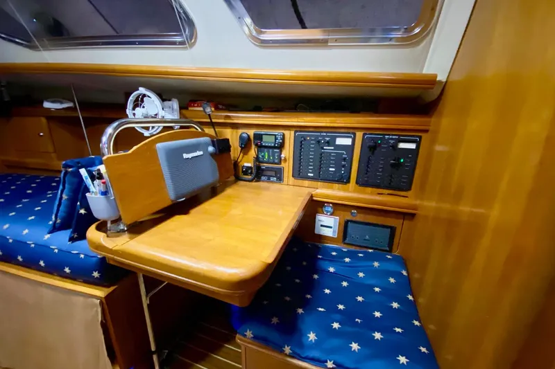Slide: The Image of Interior of 2006 Hunter 41 Deck Salon with navigation station and control panels. - 10
