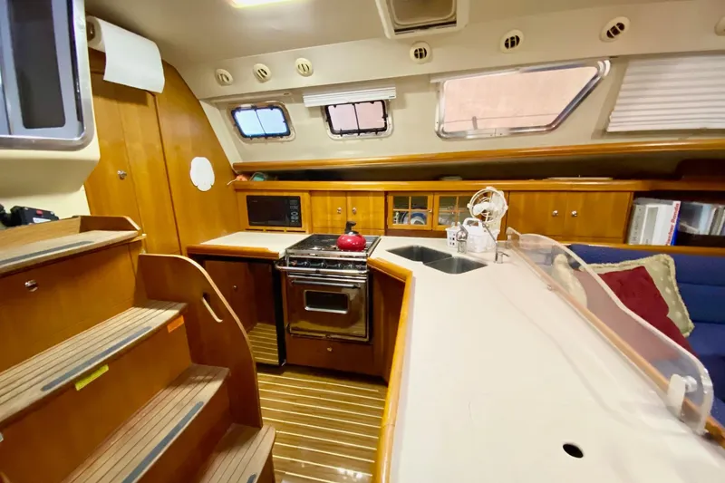 Slide: The Image of Interior of 2006 Hunter 41 Deck Salon yacht with kitchen and seating area. - 13