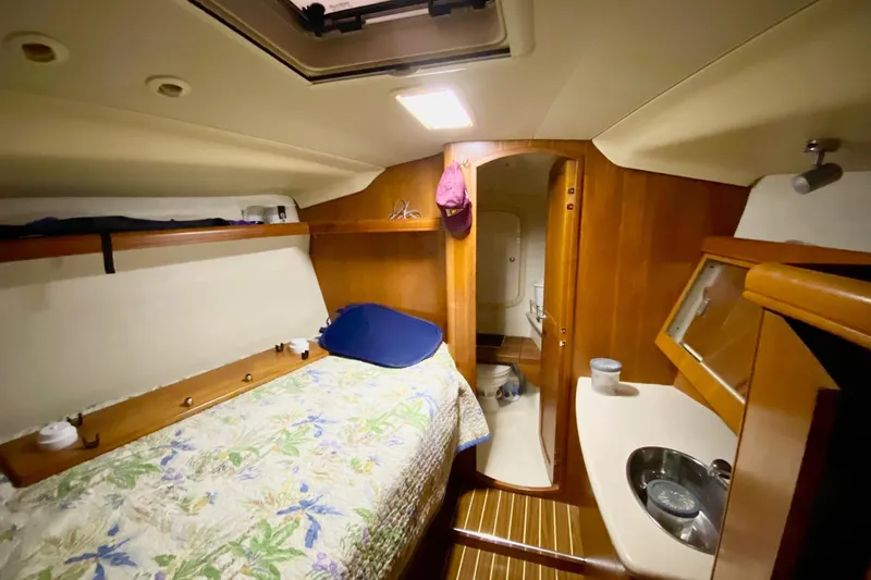 Slide: The Image of Cozy cabin interior of 2006 Hunter 41 Deck Salon with bed and sink. - 14