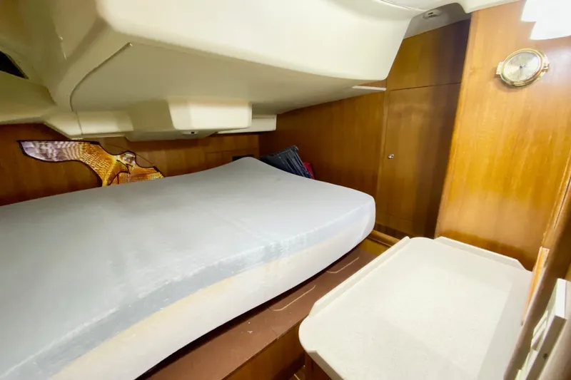 Slide: The Image of Interior cabin of 2006 Hunter 41 Deck Salon with bed and wooden paneling. - 18