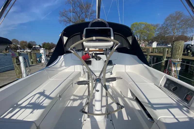 Slide: The Image of 2006 Hunter 41 Deck Salon cockpit with steering wheel, docked at marina. - 27