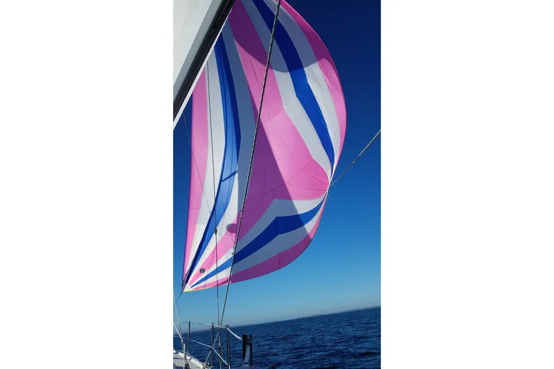 Slide: The Image of Colorful spinnaker sail on 2006 Hunter 41 Deck Salon against clear blue sky. - 3