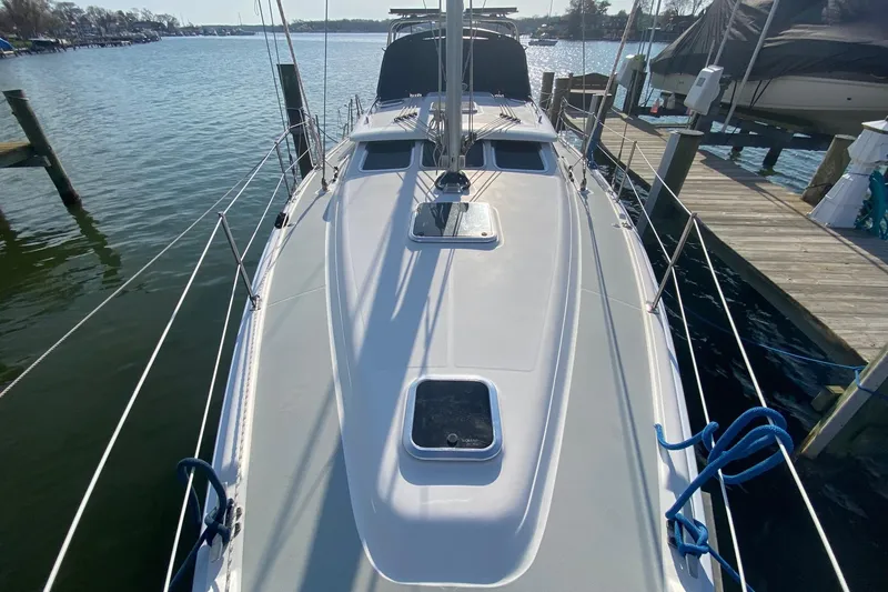 Slide: The Image of 2006 Hunter 41 Deck Salon sailboat docked, showcasing sleek deck design and marina setting. - 35