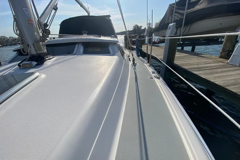 Slide: The Image of 2006 Hunter 41 Deck Salon sailboat docked, showcasing sleek deck design and marina setting. - 36