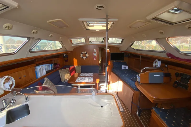 Slide: The Image of Interior of 2006 Hunter 41 Deck Salon yacht with cozy seating and wooden finishes. - 40