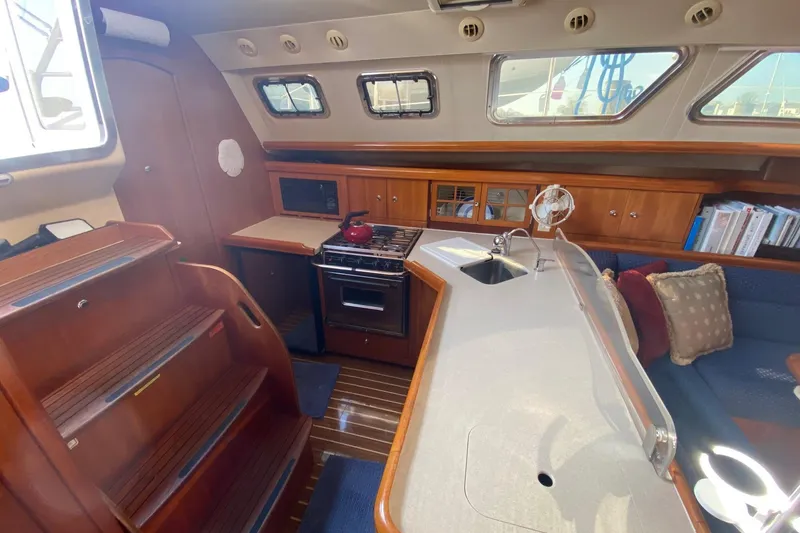 Slide: The Image of Interior of 2006 Hunter 41 Deck Salon yacht with kitchen and seating area. - 41