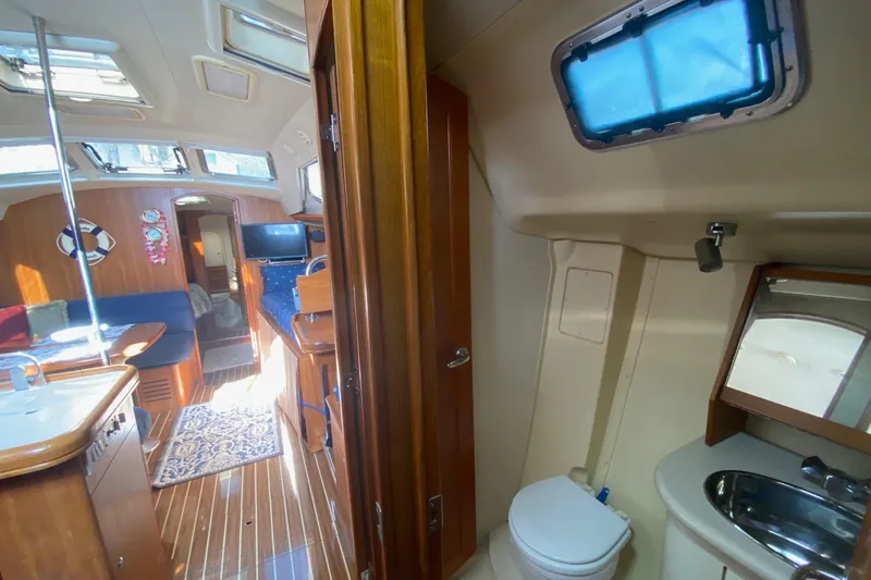 Slide: The Image of Interior of 2006 Hunter 41 Deck Salon yacht with wood finishes and modern amenities. - 44