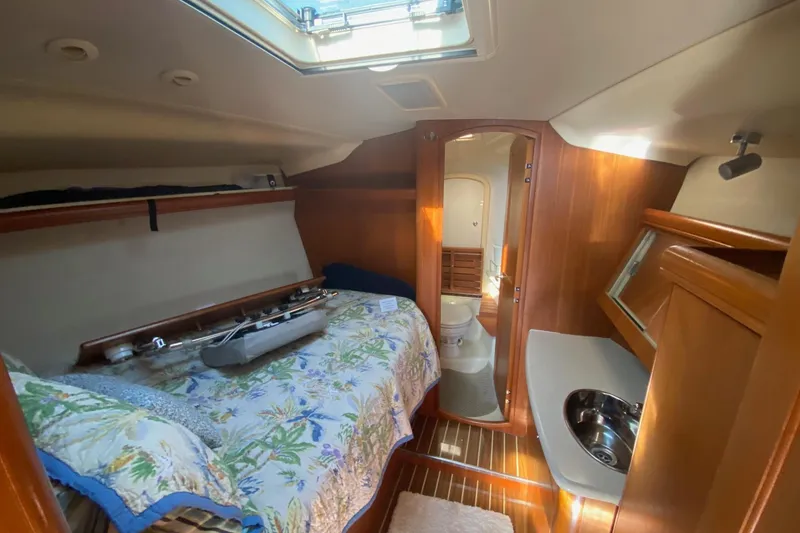 Slide: The Image of Cozy cabin interior of 2006 Hunter 41 Deck Salon with bed, sink, and bathroom. - 45