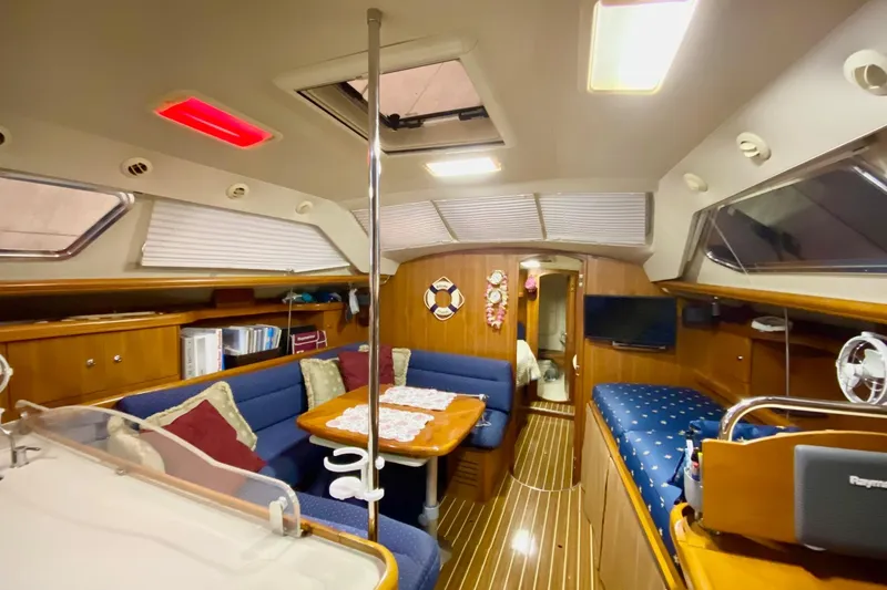Slide: The Image of Interior of 2006 Hunter 41 Deck Salon yacht with cozy seating and wooden finishes. - 5