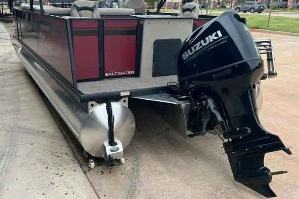 Slide: The Image of 2023 Viaggio Lago F pontoon boat with Suzuki outboard motor, parked on concrete. - 3