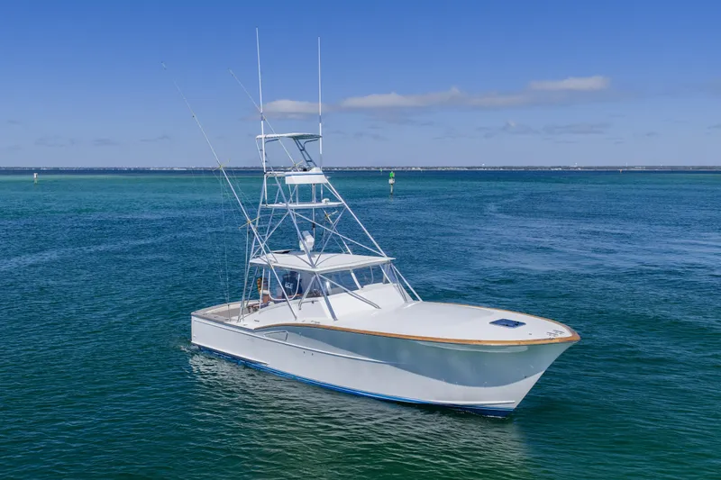 The Image of 1994 Daytona Express boat on calm blue ocean waters under clear sky. - 0