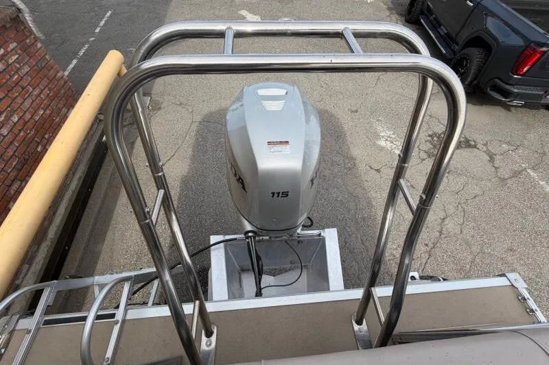 Slide: The Image of 2013 SunChaser PONTOON 22 with 115 HP outboard motor, parked on pavement. - 13