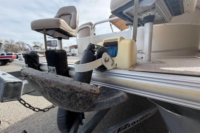 Slide: The Image of 2013 SunChaser PONTOON 22 boat on trailer, featuring seating and winch system. - 14