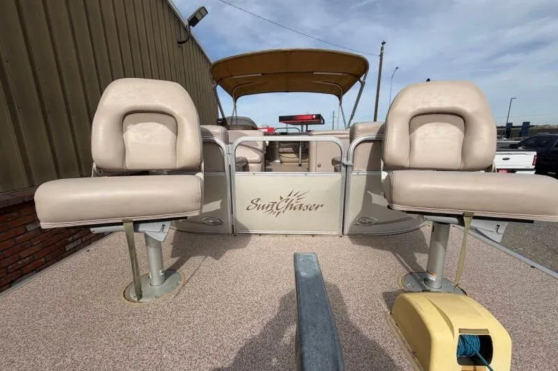 Slide: The Image of 2013 SunChaser PONTOON 22 boat with beige seating and canopy, docked outdoors. - 15