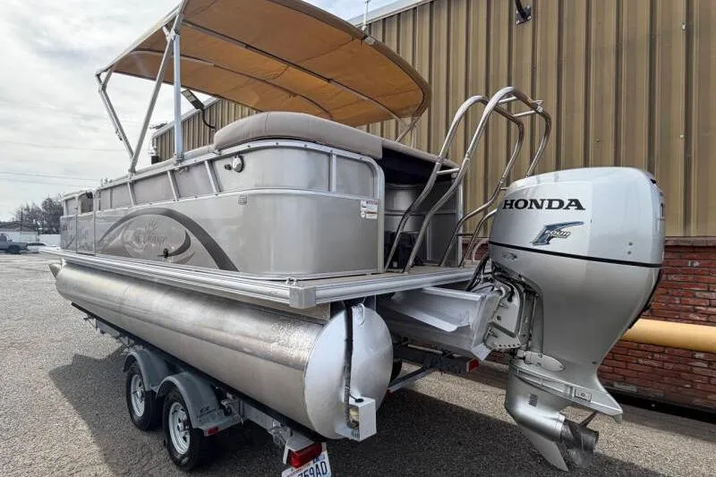 Slide: The Image of 2013 SunChaser PONTOON 22 with Honda outboard motor on trailer. - 3