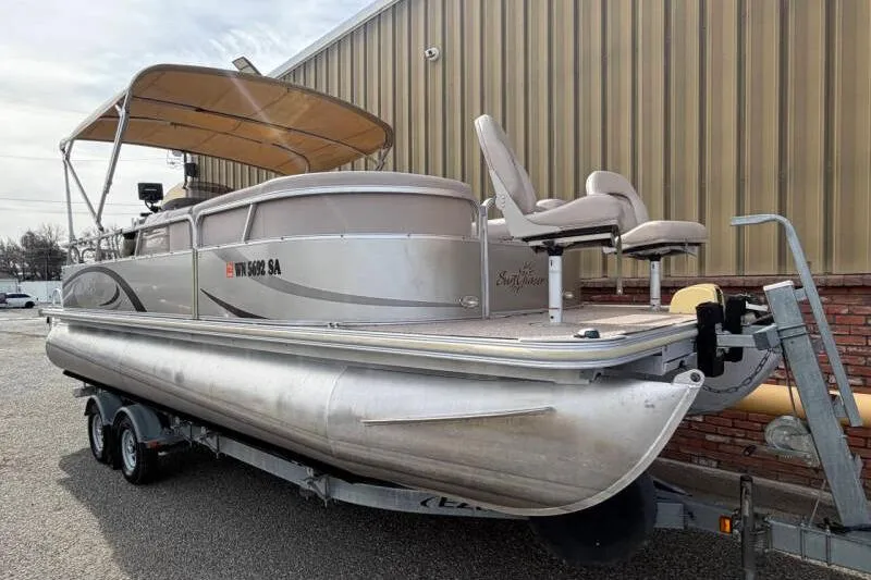 Slide: The Image of 2013 SunChaser PONTOON 22 boat on trailer, parked near a building. - 5