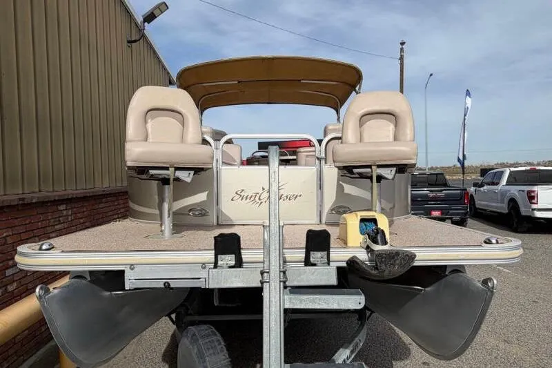 Slide: The Image of 2013 SunChaser PONTOON 22 boat on trailer, beige seats, outdoor setting. - 7