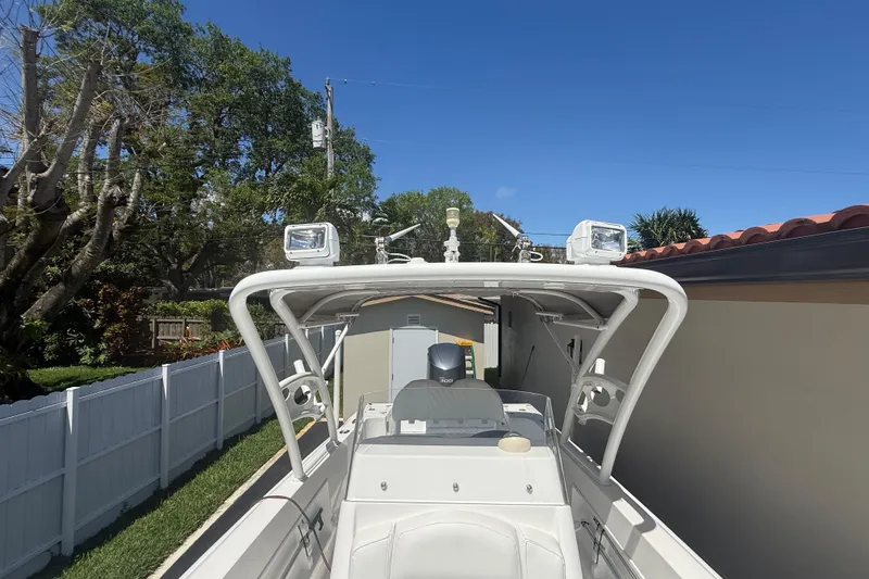 Slide: The Image of Concept 27 boat, 2015 model, parked outdoors with clear blue sky background. - 107