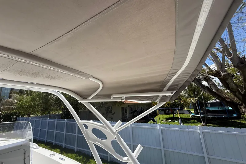 Slide: The Image of 2015 Concept 27 boat canopy with white frame, outdoor setting. - 117