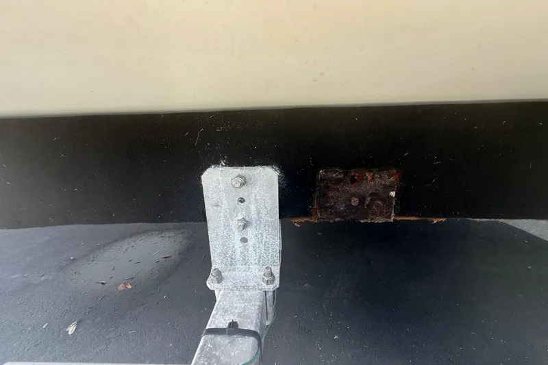 Slide: The Image of Close-up of a 2015 Concept 27 trailer hitch with visible rust and metal bolts. - 121