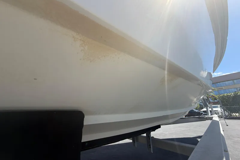 Slide: The Image of Close-up of a 2015 Concept 27 boat hull on a trailer under sunlight. - 122