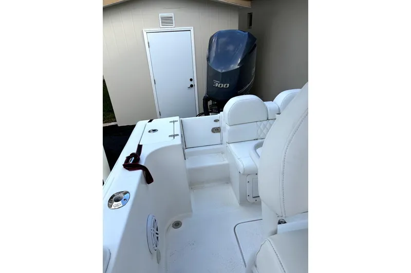 Slide: The Image of Outboard motor on a Concept 27 boat, 2015 model, parked beside a building. - 13