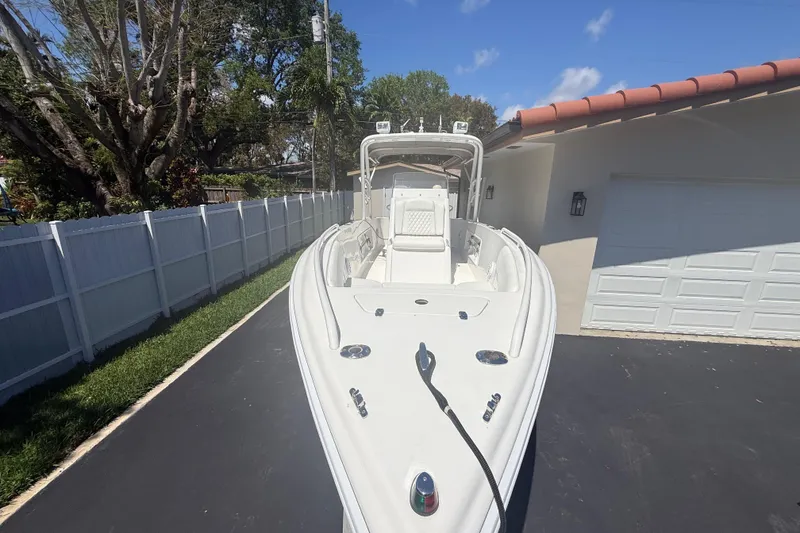 Slide: The Image of White Concept 27 boat from 2015 parked on a driveway beside a house. - 131