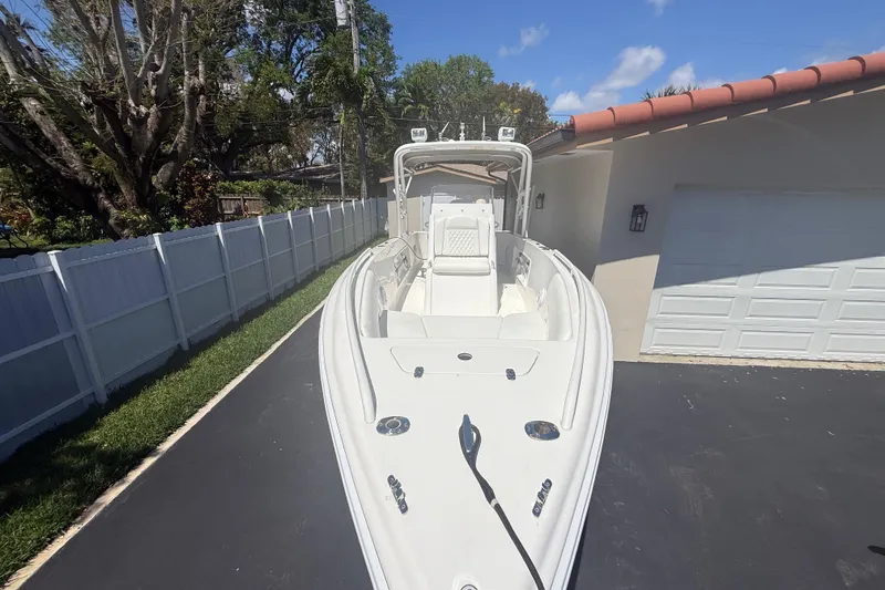Slide: The Image of 2015 Concept 27 boat parked in driveway, surrounded by white fence and trees. - 132
