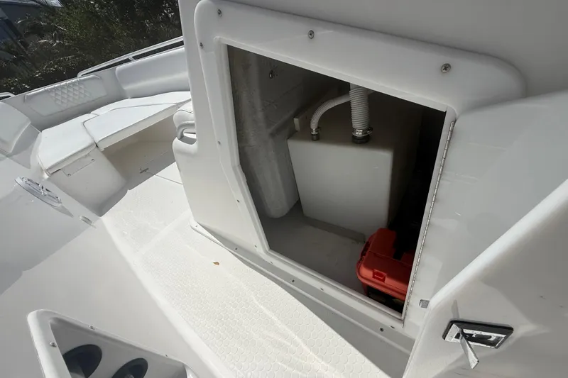 Slide: The Image of Storage compartment on a 2015 Concept 27 boat, featuring seating and equipment access. - 140