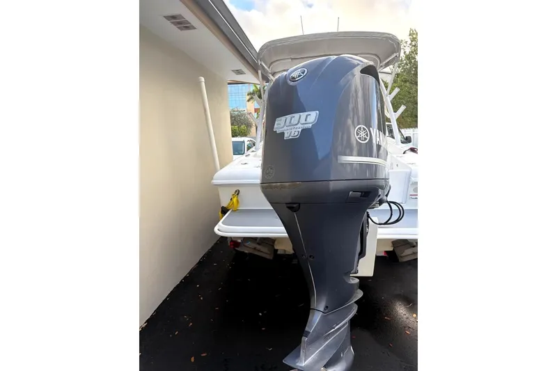 Slide: The Image of 2015 Concept 27 boat on trailer in driveway, overcast sky. - 2