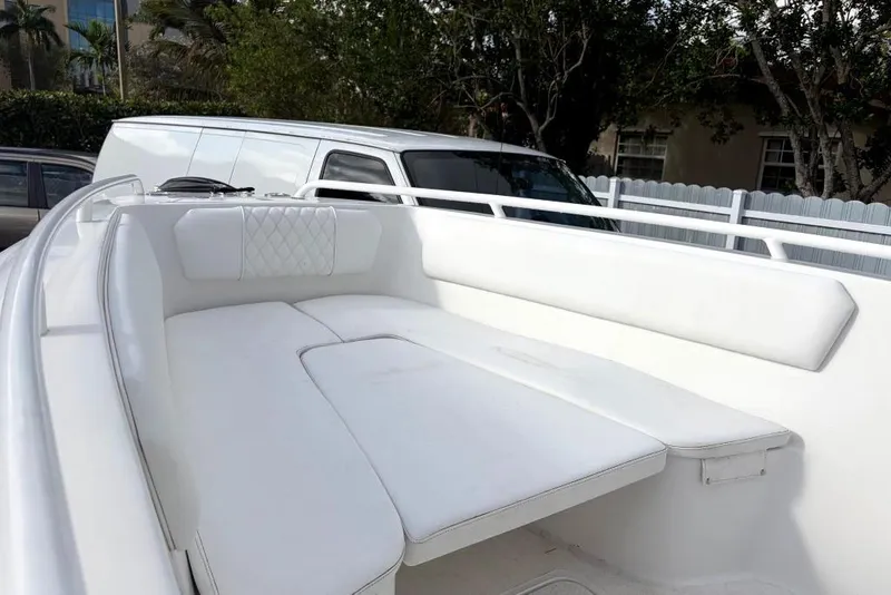 Slide: The Image of White Concept 27 boat on trailer, parked in driveway, sunny day, 2015 model. - 32