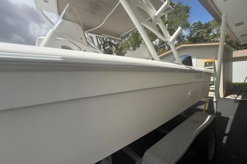 Slide: The Image of White 2015 Concept 27 boat on trailer under a canopy, side view. - 35