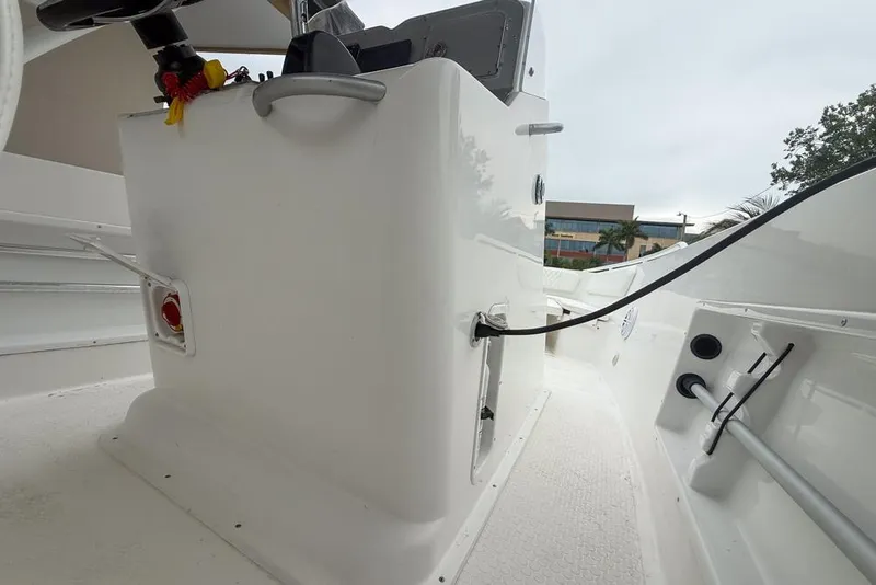 Slide: The Image of 2015 Concept 27 boat on trailer in driveway, sunny day, white car nearby. - 38