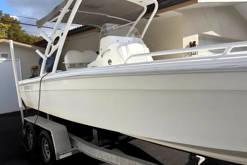 Slide: The Image of 2015 Concept 27 boat on trailer in driveway near garage. - 4