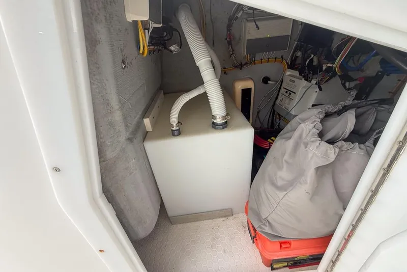 Slide: The Image of White 2015 Concept 27 boat on trailer, parked outdoors under clear blue sky. - 40