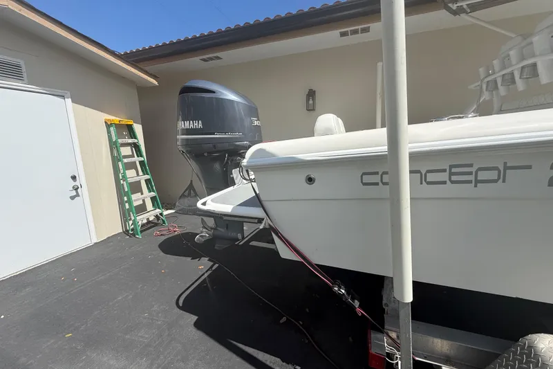 Slide: The Image of Boat with Yamaha engine and ladder, Concept 27 model, 2015, parked near a building. - 44